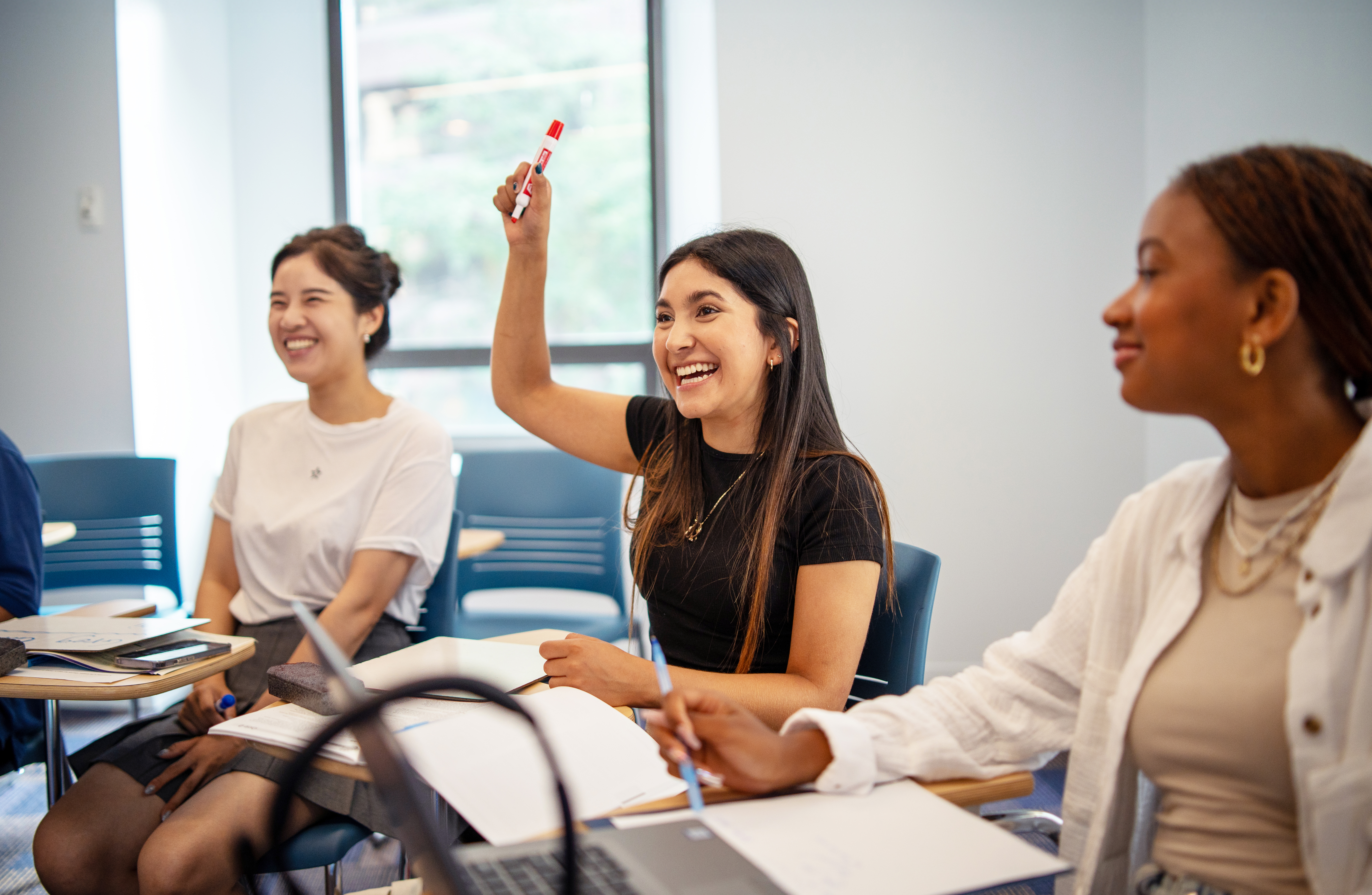 Student raising her hand to speak in class