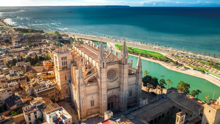 La Seu Cathedral in Palma de Mallorca, Spain, featuring stunning Gothic architecture, intricate details, and vibrant stained-glass windows overlooking the waterfront