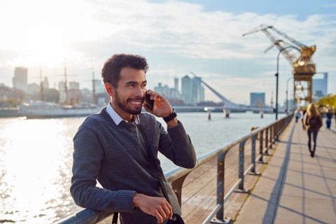 Man talking on the phone by the river in Buenos aires City Center, Argentina