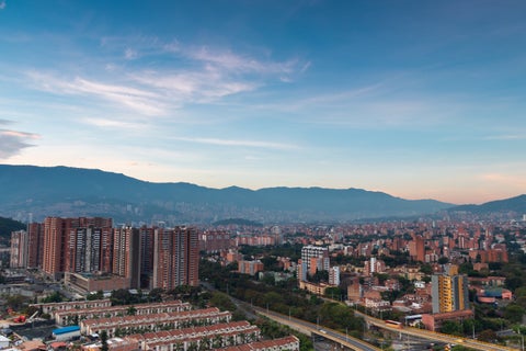 A sunrise over the city of Medellín reveals a panorama as soft golden light bathes the Aburrá Valley.