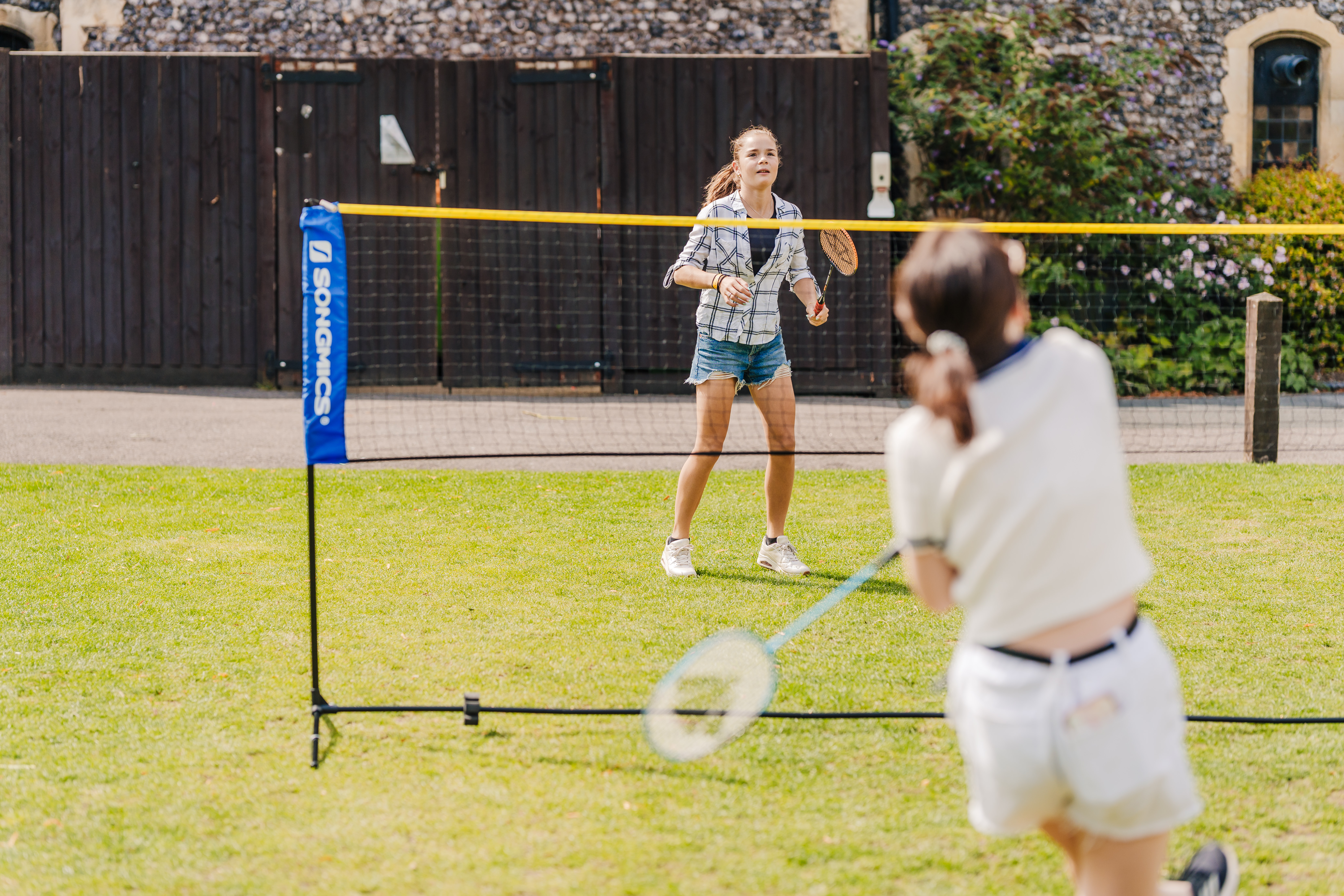 Two students playing badminton
