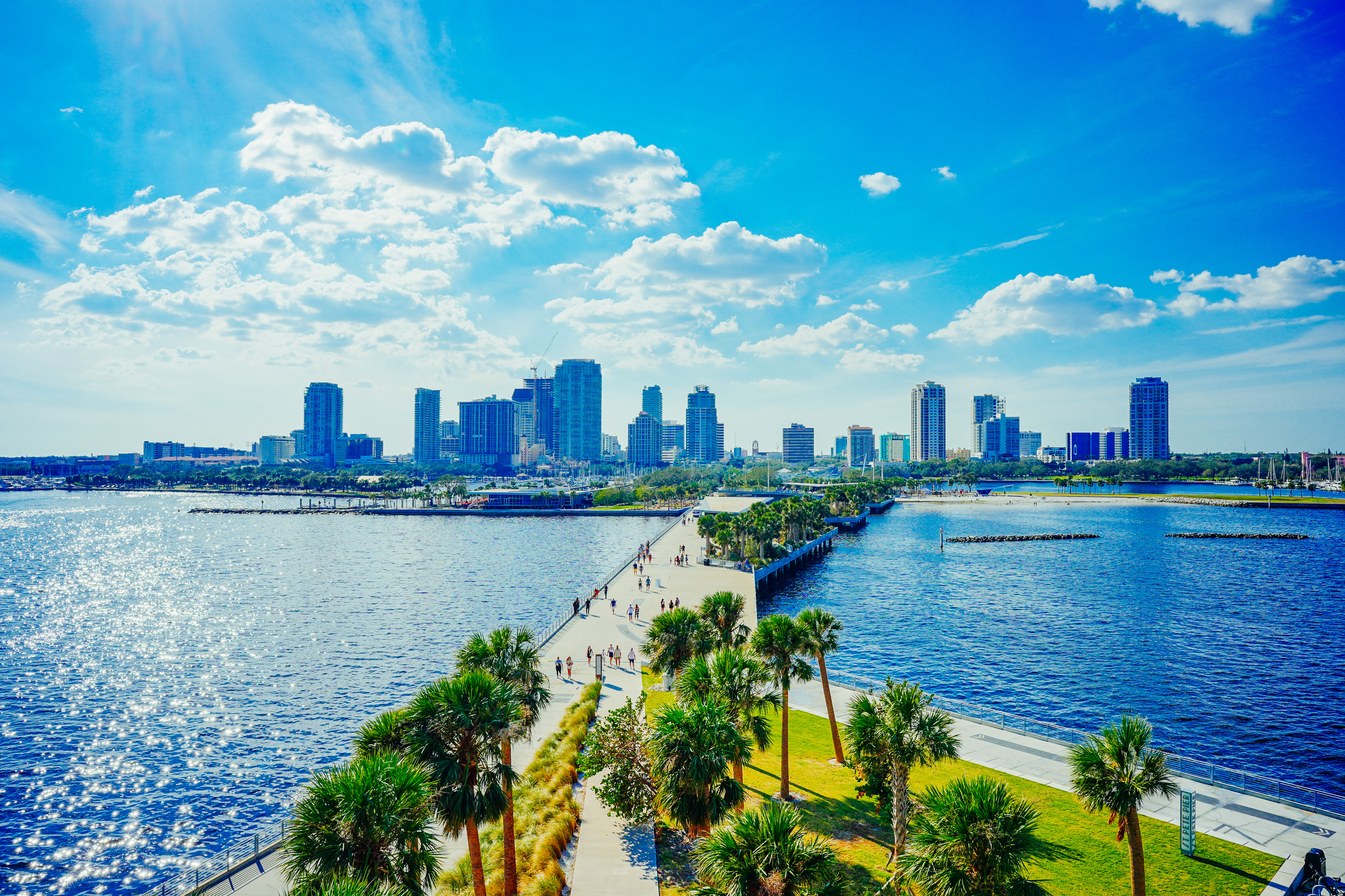 Walking path on the St. Pete Pier stretching over Tampa Bay with the downtown St. Petersburg skyline in the background