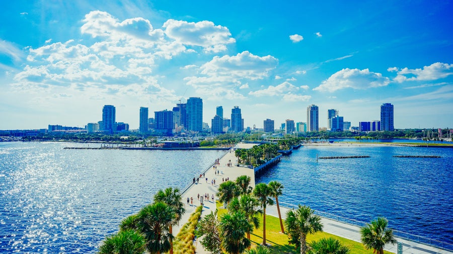 Walking path on the St. Pete Pier stretching over Tampa Bay with the downtown St. Petersburg skyline in the background