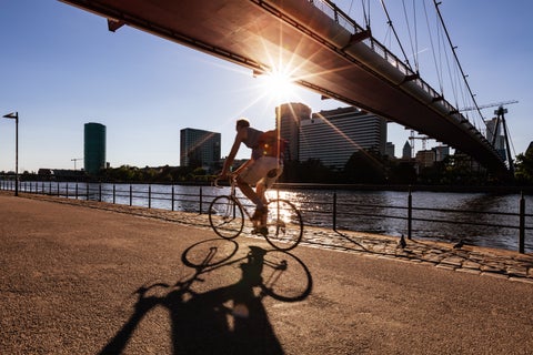 Biker crossing bellow the Eiserner Steg (Iron Bridge) next to the Main River at Frankfurt, Germany
