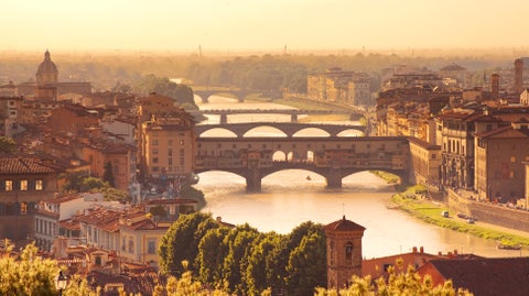 Aerial view of the historic Ponte Vecchio in Florence with its iconic medieval bridge spanning the Arno River