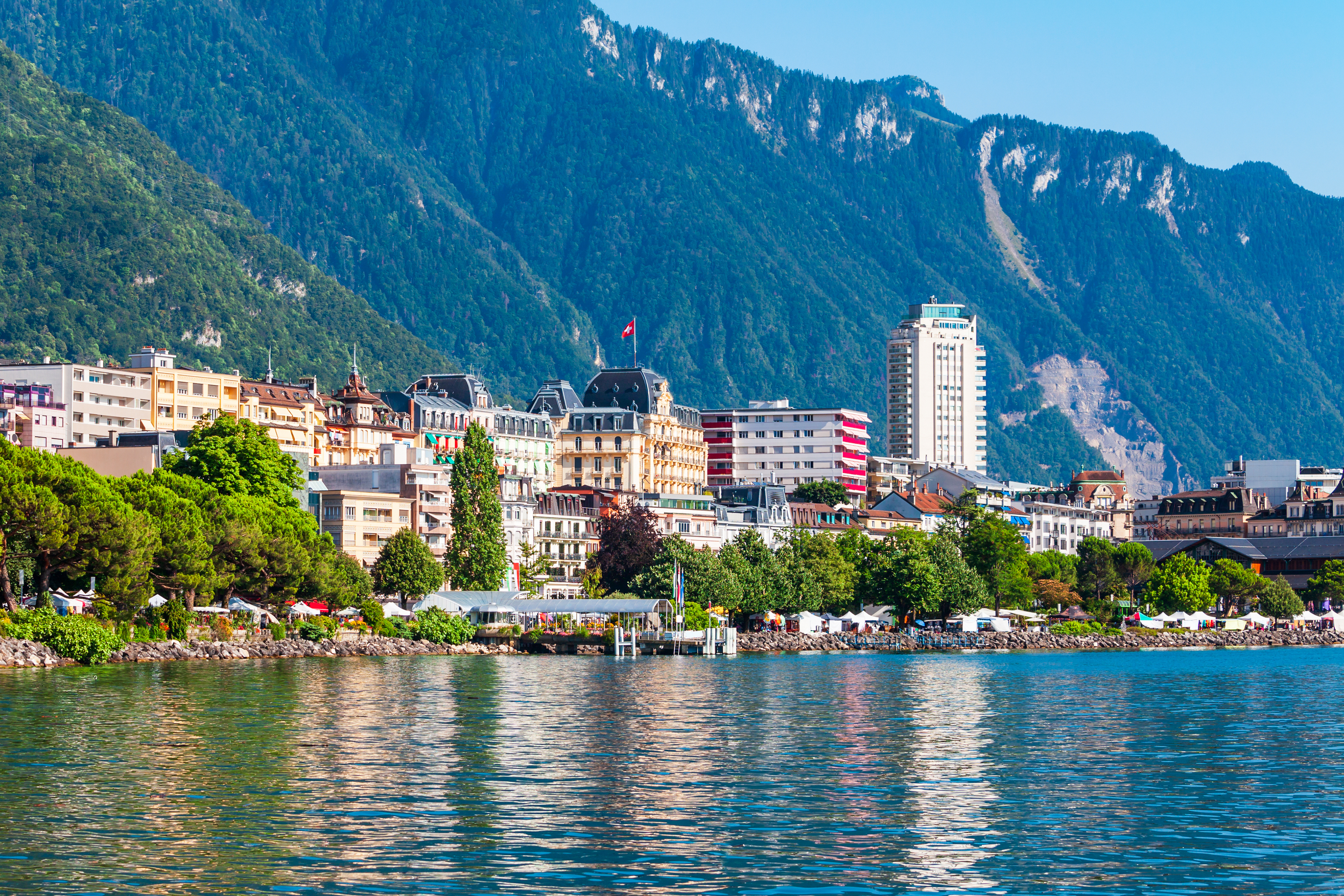 Montreux town on Lake Geneva with waterfront and mountains in the background, scenic view of Swiss Riviera coastal landscape
