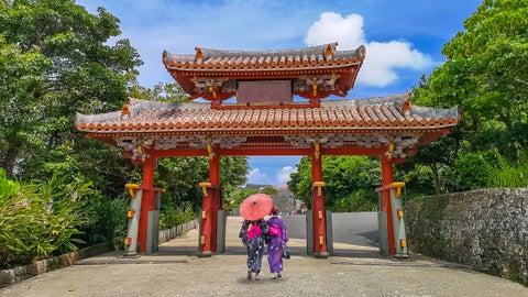 Typical Okinawan Shuri-style architecture with Japanese girls wearing traditional Ryusou (Ryukyuan kimono) in Okinawa, Japan