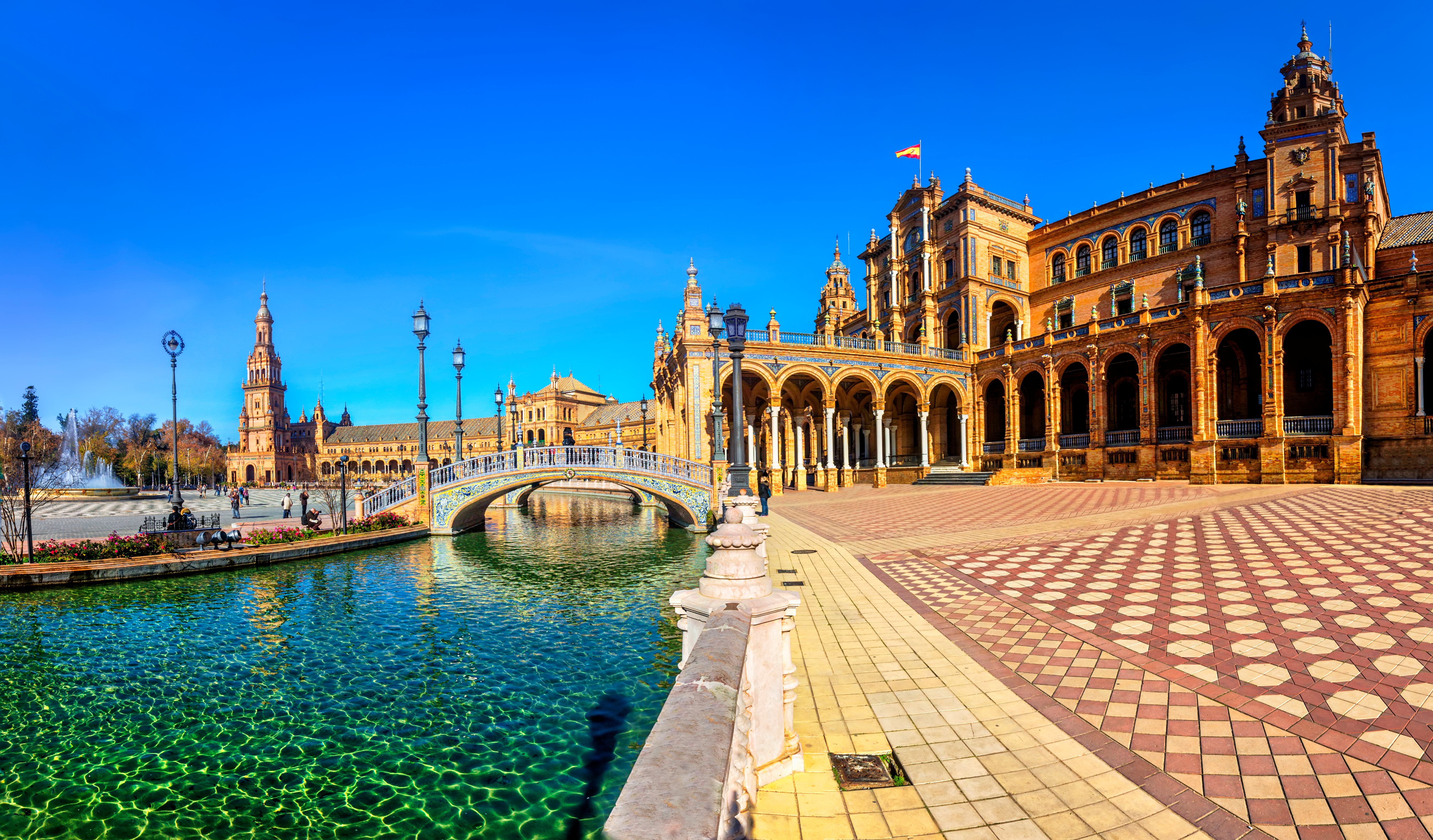 Plaza de España in Seville, Andalusia, Spain, on a bright sunny day with clear blue skies and vibrant architecture
