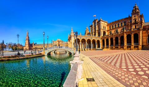 Plaza de España in Seville, Andalusia, Spain, on a bright sunny day with clear blue skies and vibrant architecture