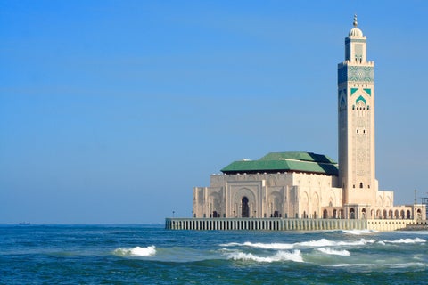 Mausoleum of Mohammed V in Rabat, Morocco, featuring traditional Moroccan architecture with white walls and green-tiled roof