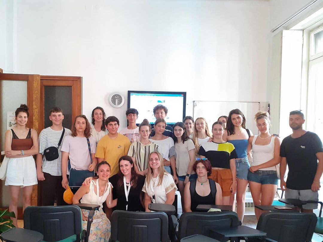 Junior and teen students at Salerno Summer Camp ESL School taking group photos in classroom, smiling and having fun
