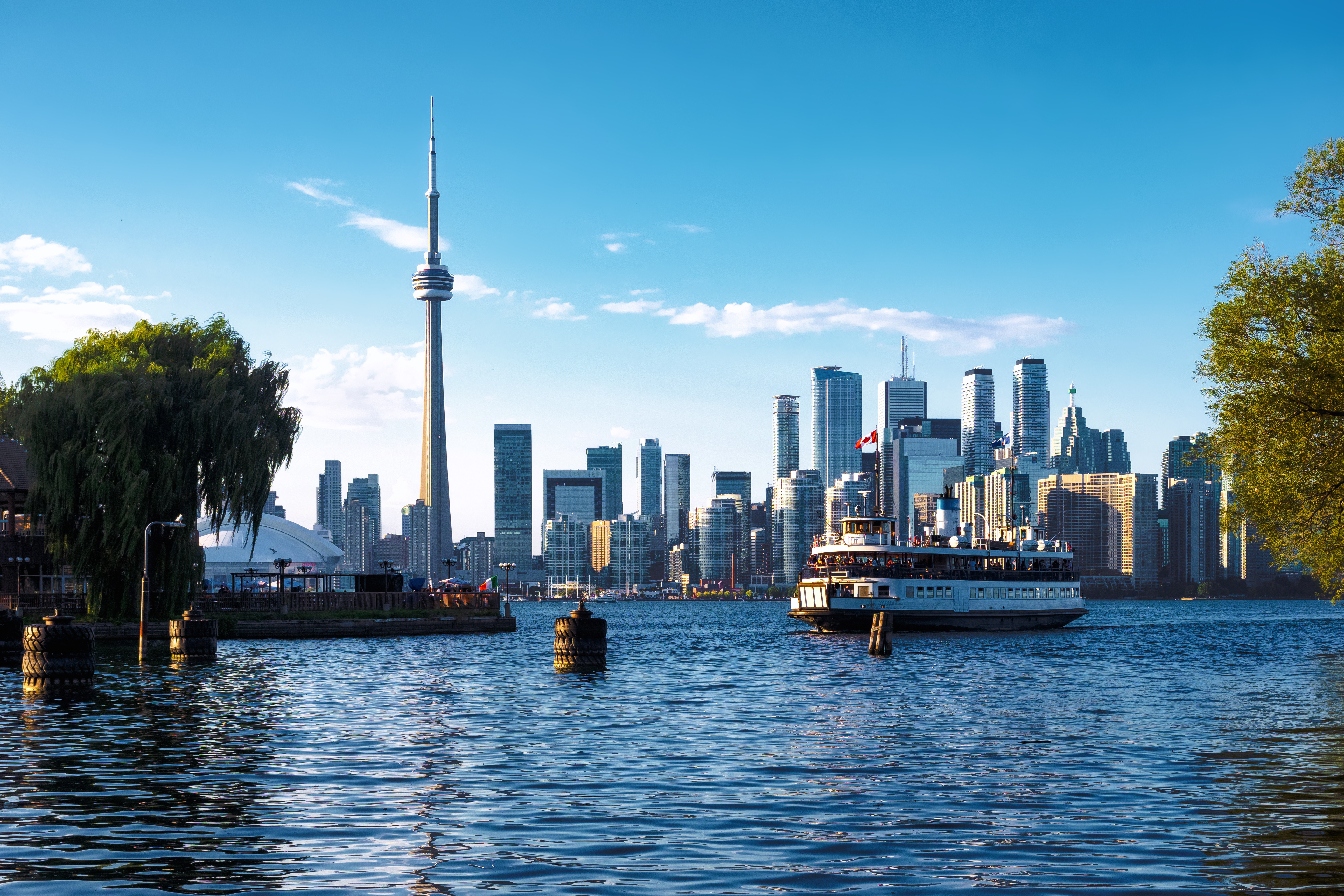 View of Skyline and Ferry Boat Arriving at Centre Island in Toronto, Ontario, Canada,