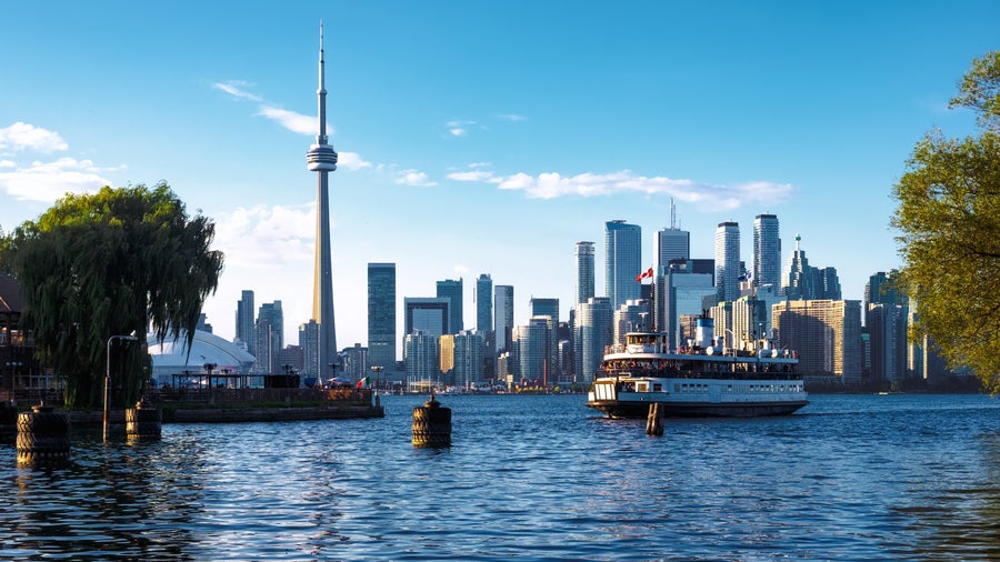 View of Skyline and Ferry Boat Arriving at Centre Island in Toronto, Ontario, Canada,