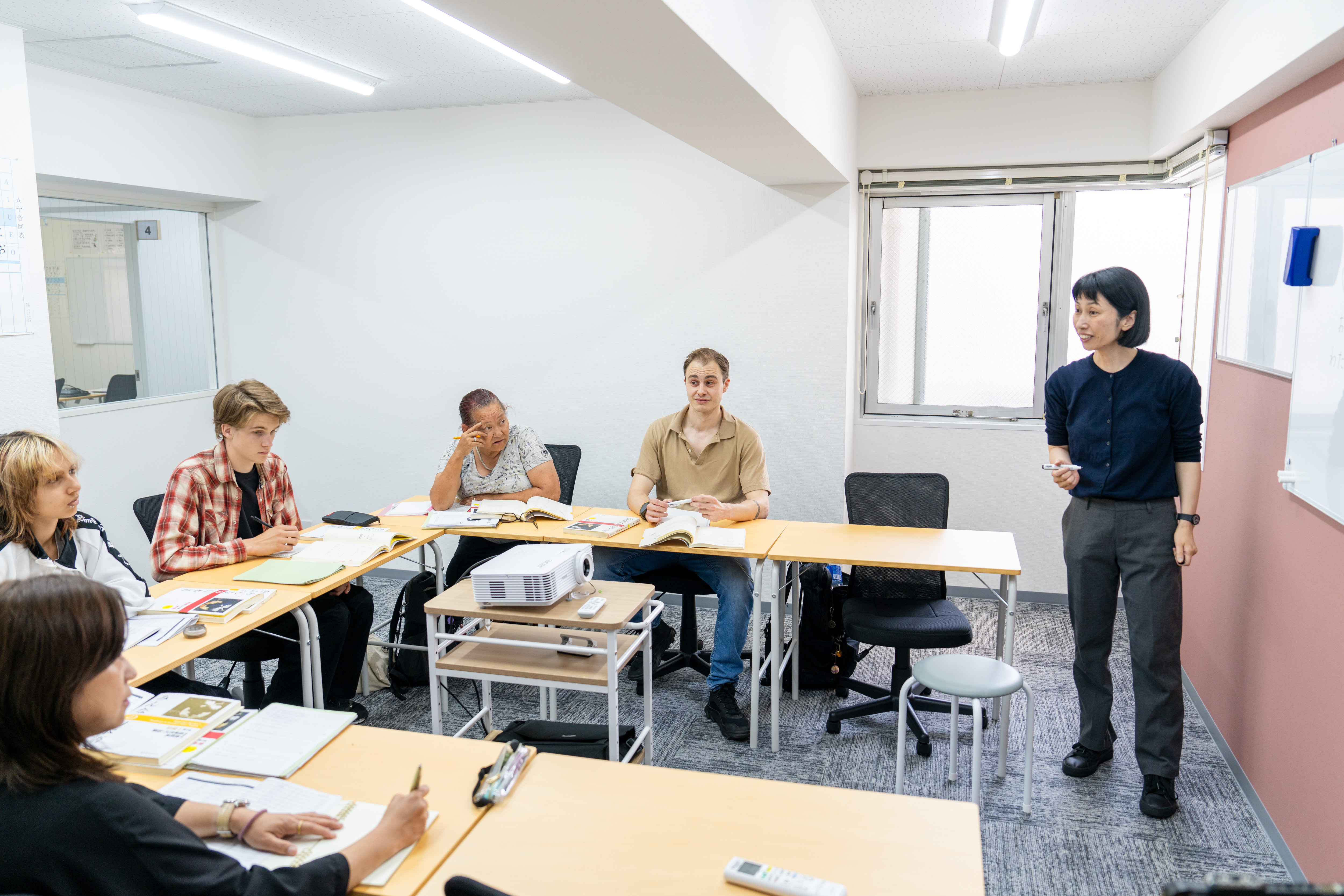 A teacher in front of the white board at Genki Nagoya