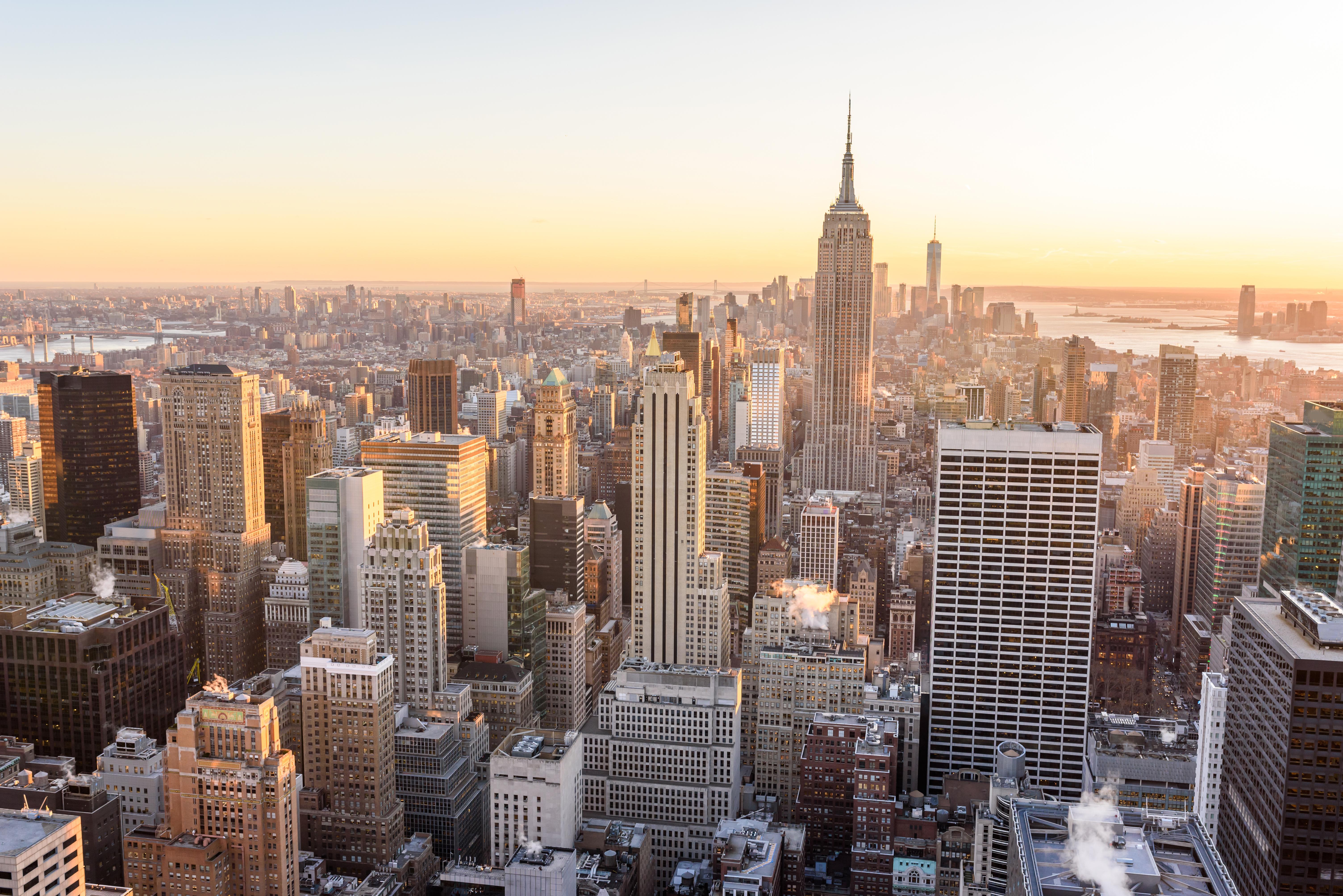 Aerial view of New York City skyline with modern skyscrapers at sunset