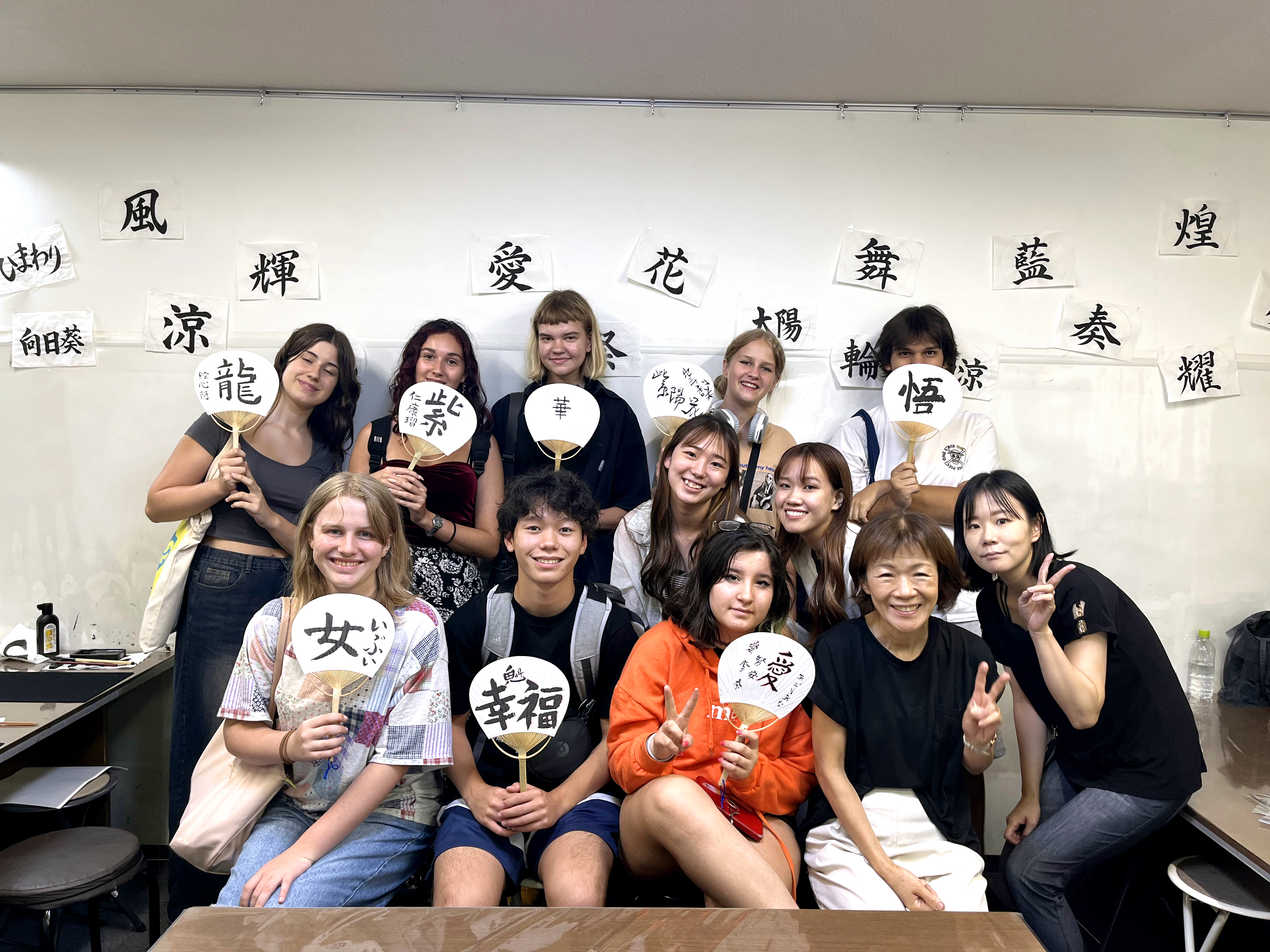 A group of students with handmade fans at the Japanese Summer course