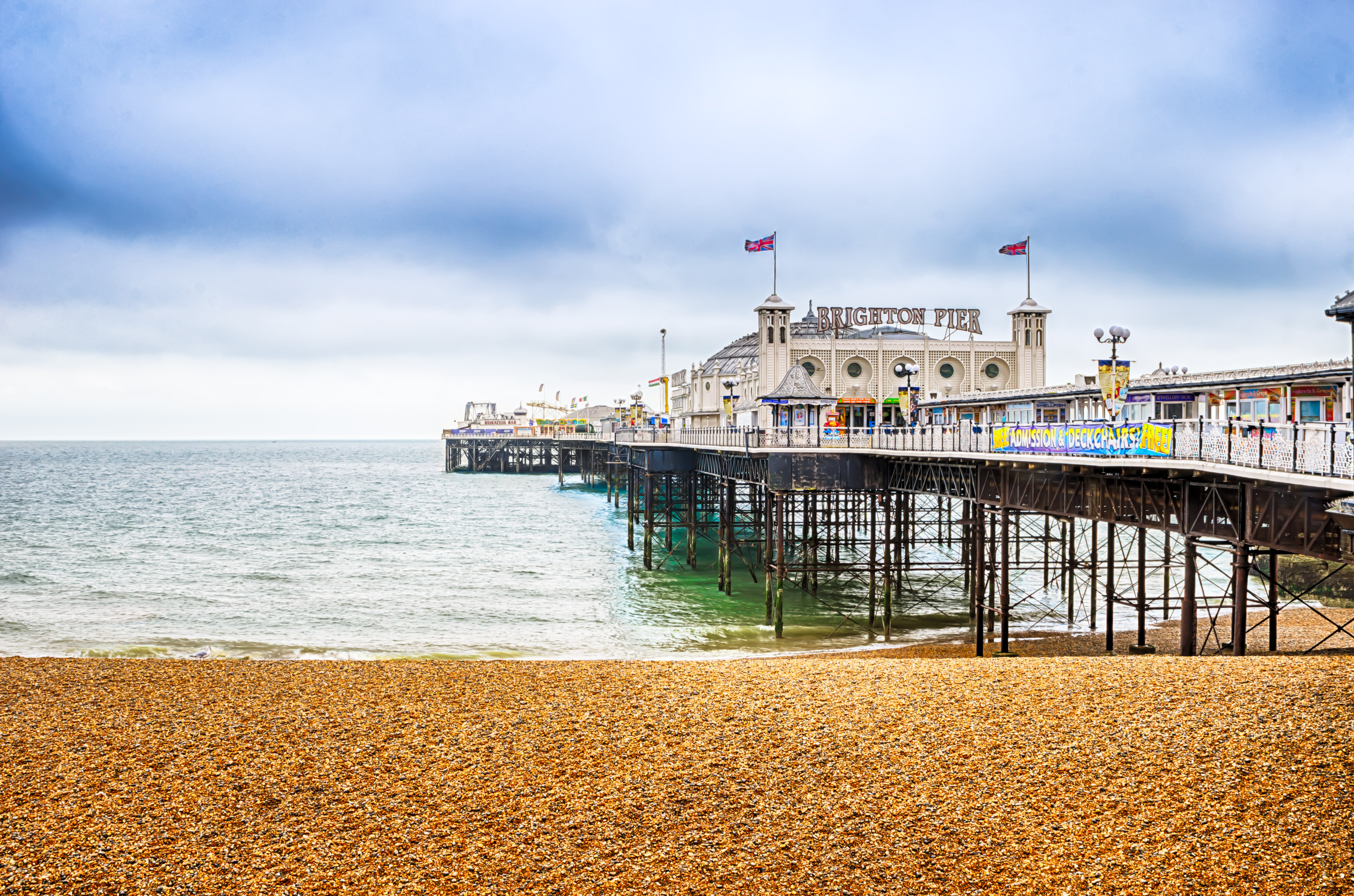 Brighton Pier with amusement rides and colorful lights extending into the English Channel, United Kingdom