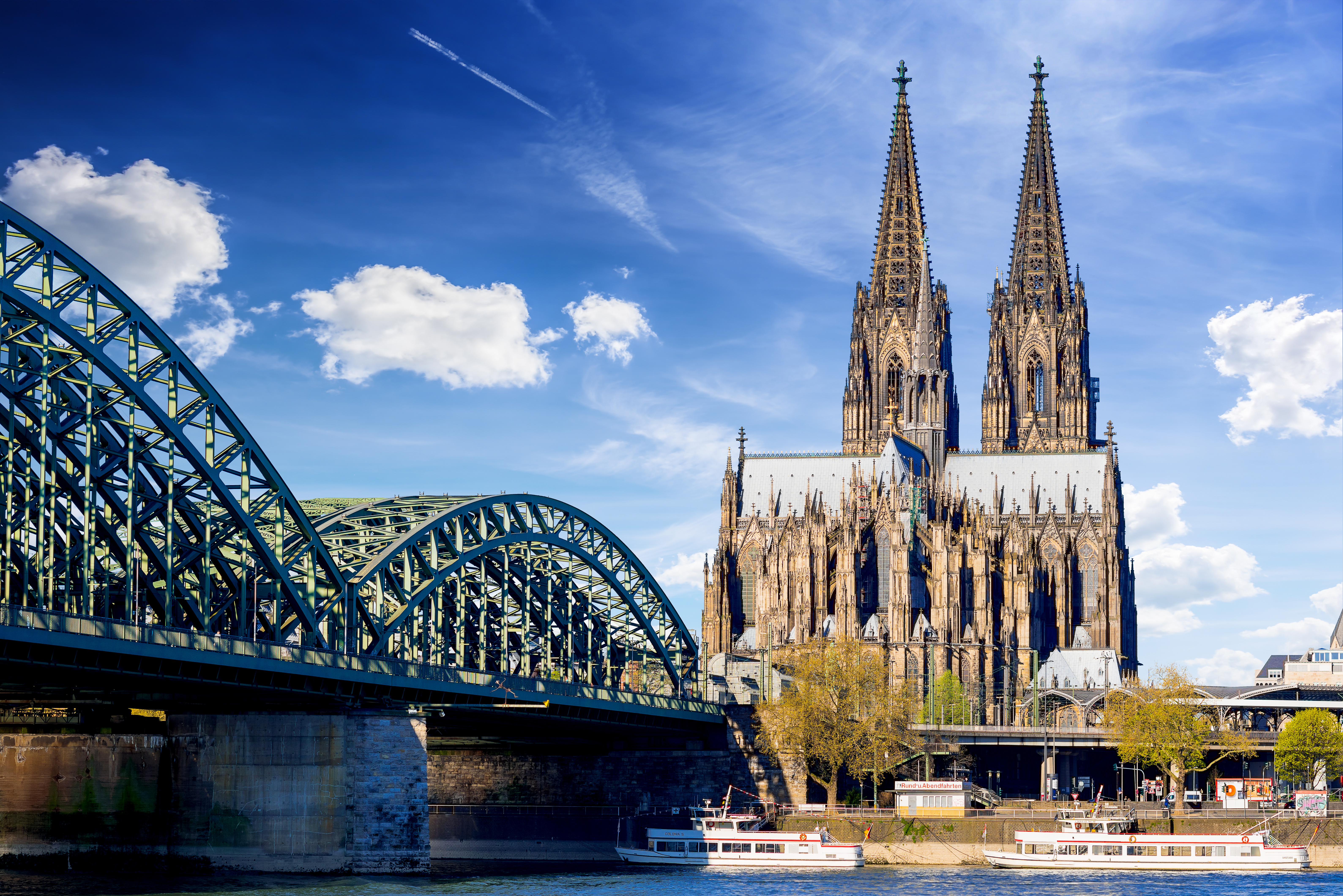 Hohenzollern Bridge spanning the Rhine River with Cologne Cathedral in the background, Cologne, Germany