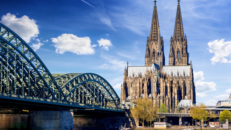 Hohenzollern Bridge spanning the Rhine River with Cologne Cathedral in the background, Cologne, Germany