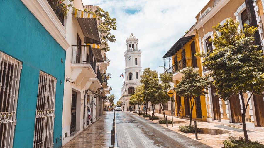 Colourful colonial houses in Santo Domingo's Ciudad Colonial with the white Santo Domingo Cathedral in the background