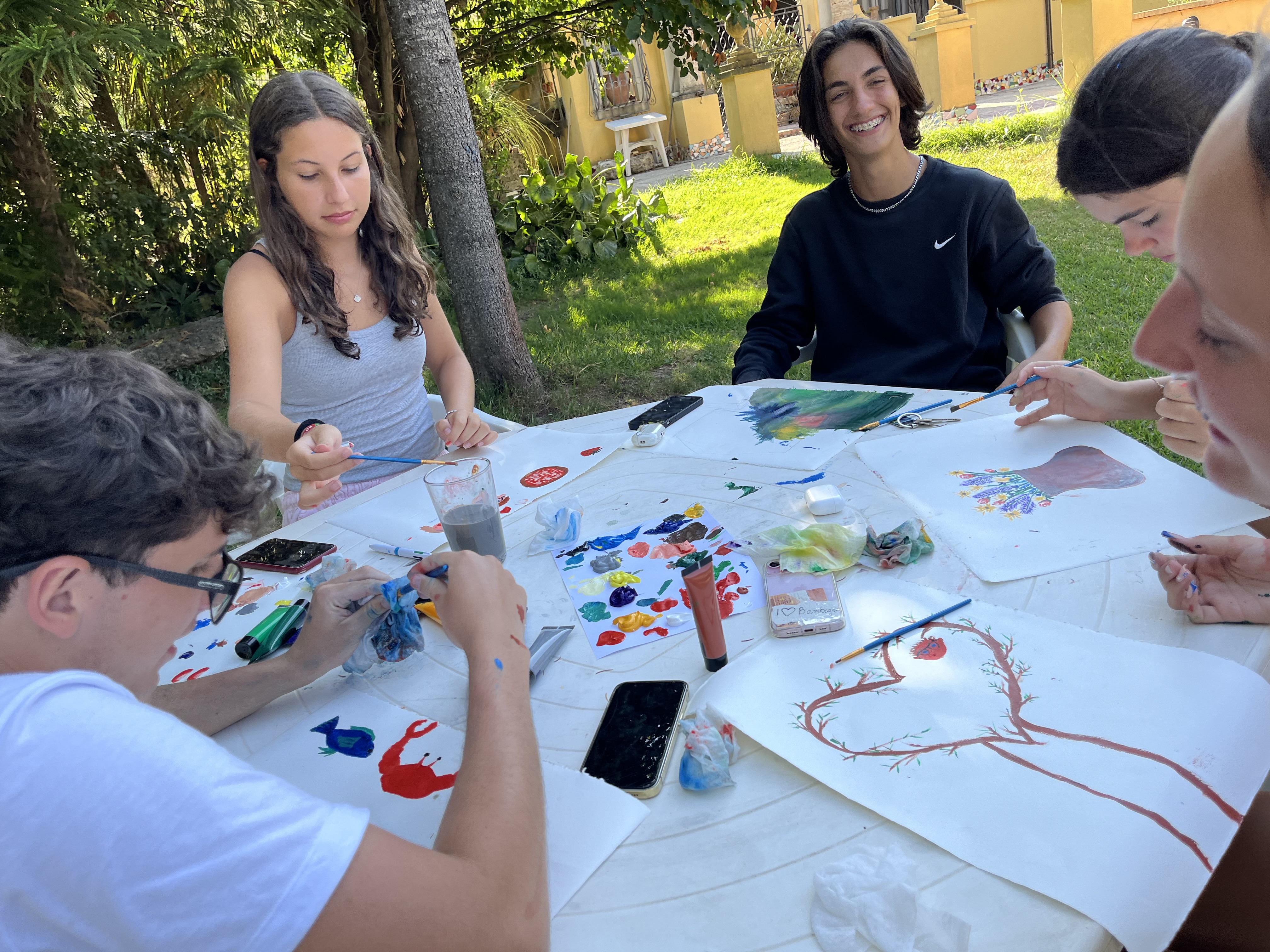 Students outside in school garden painting
