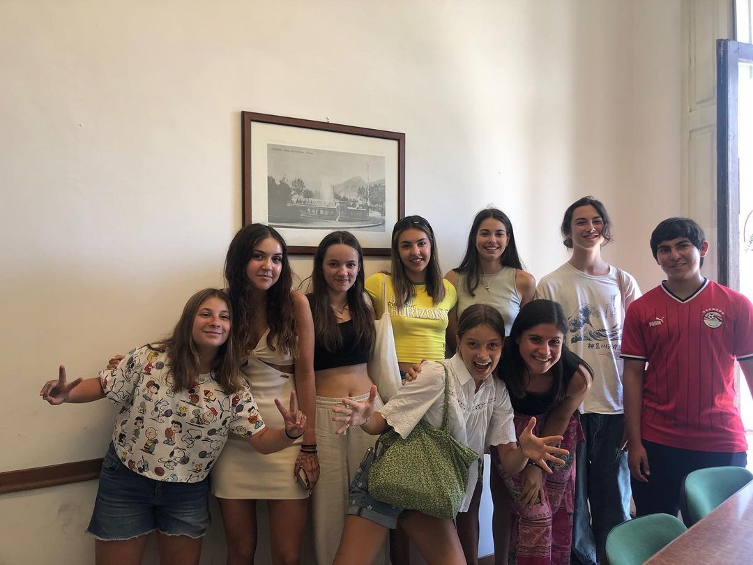 Junior and teen students at Salerno Summer Camp ESL School taking group photos in classroom, smiling and having fun
