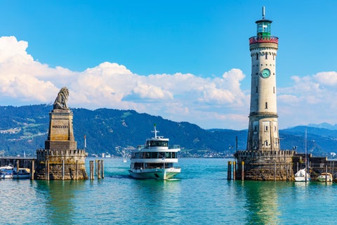 Boat sailing in the Harbour next to a Lighthouse Lindenberg, Germany