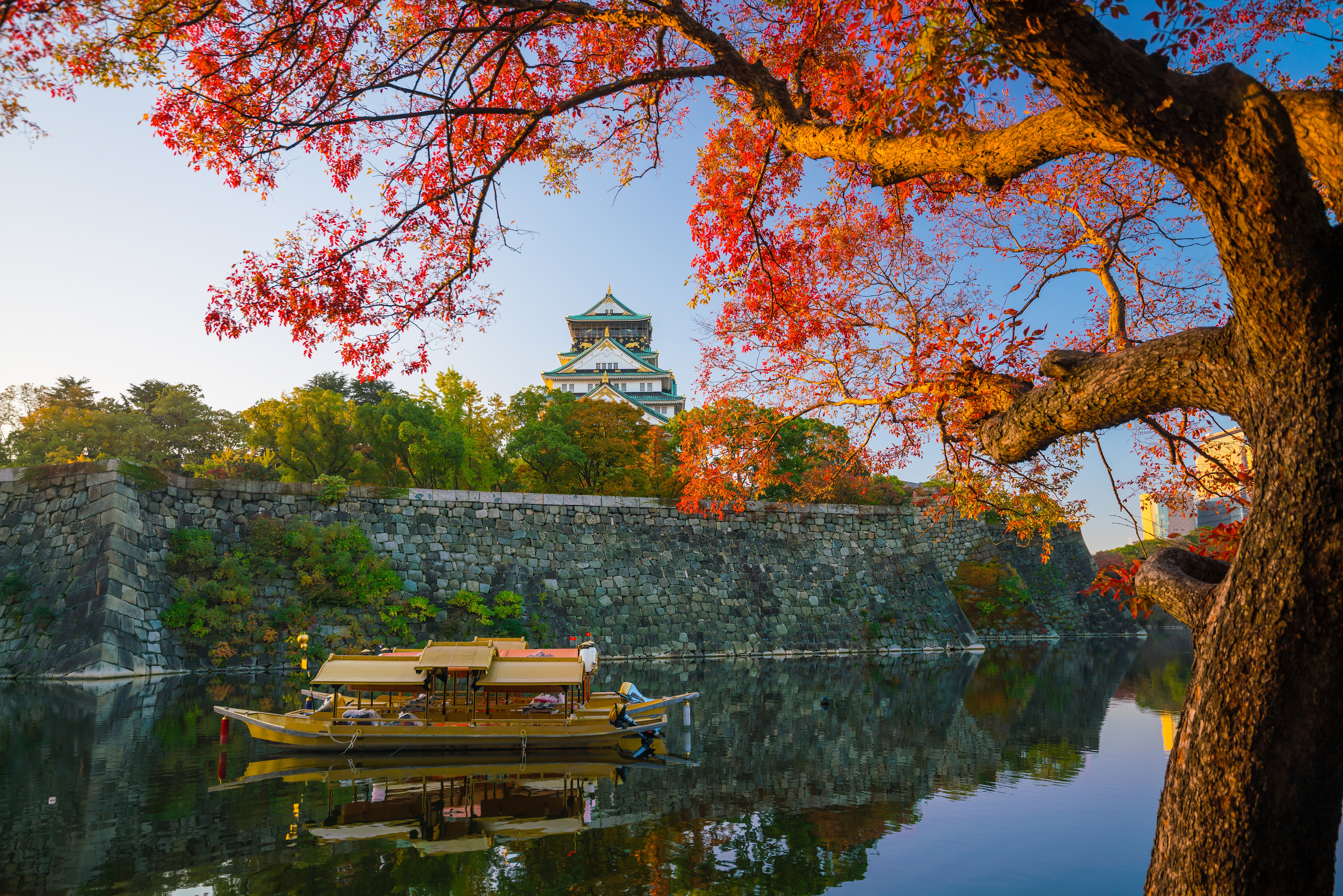 A view of the Osaka Castle on the hill above the river