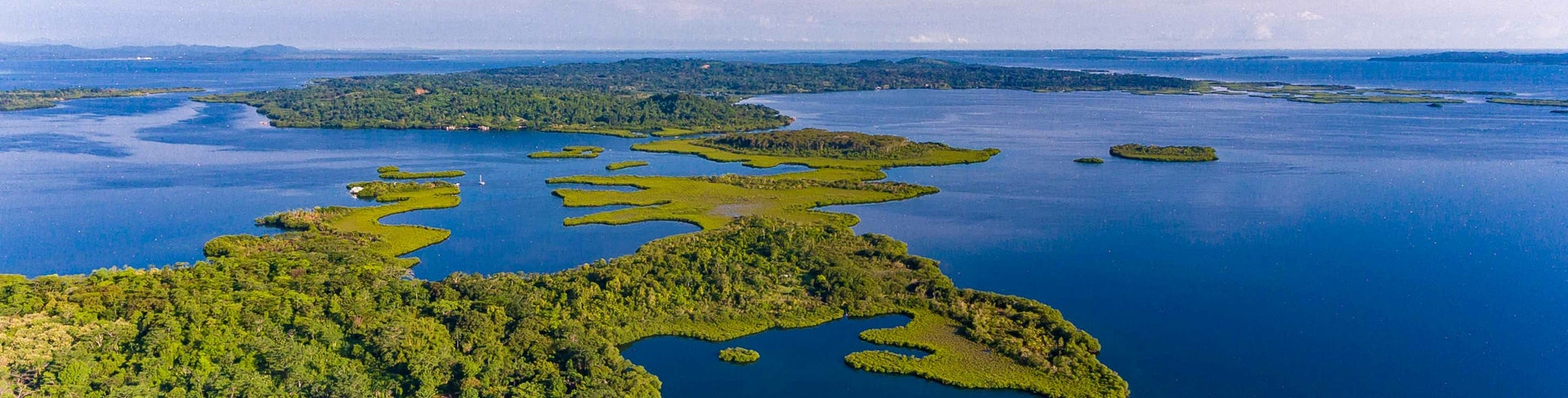 Aerial view of lush green islands and turquoise waters of the Caribbean Sea in the Bocas del Toro Archipelago, Panama