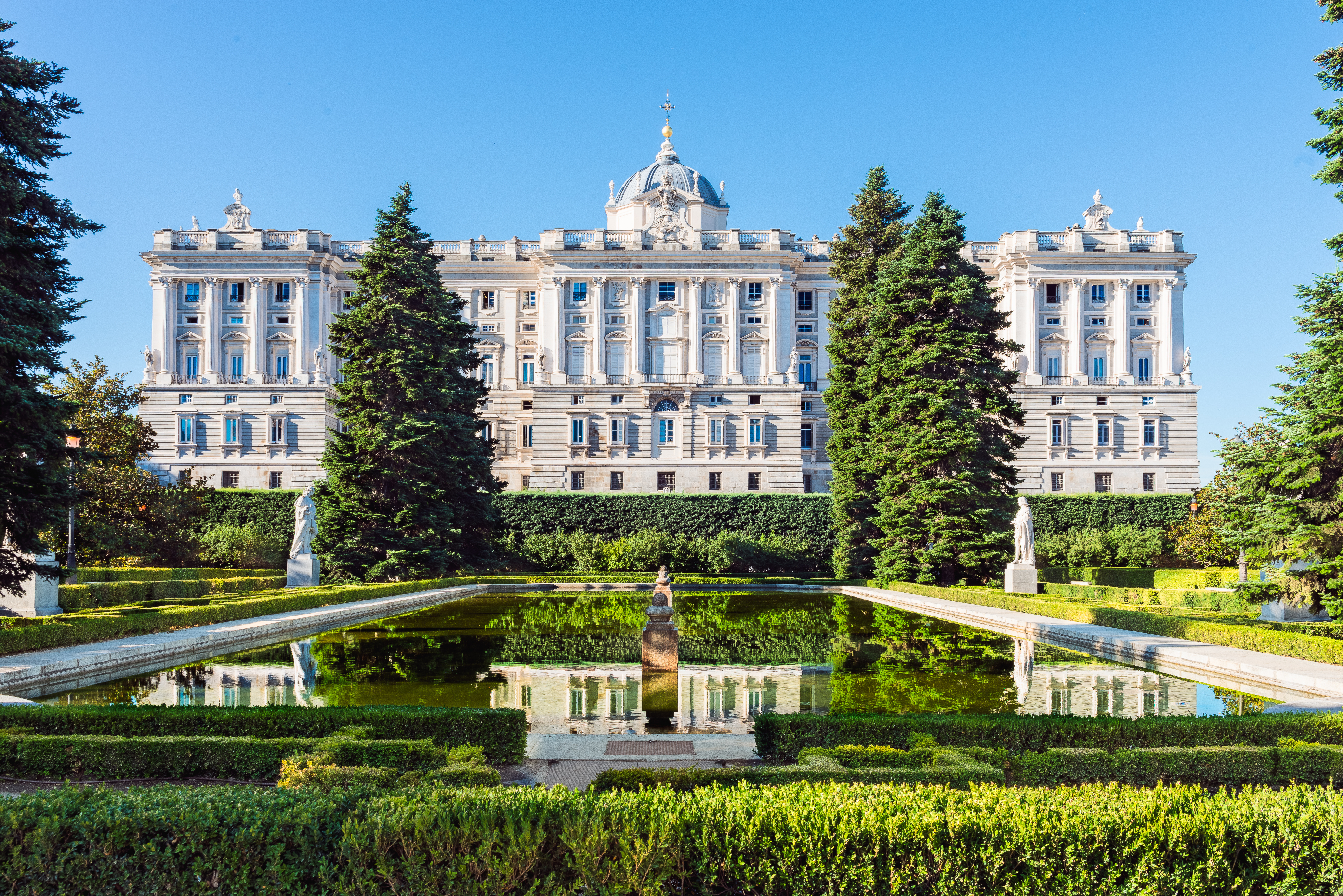 Historic building in Madrid, Spain, with a beautifully landscaped garden in front