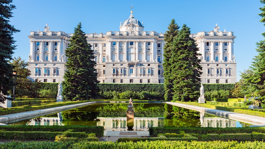 Historic building in Madrid, Spain, with a beautifully landscaped garden in front