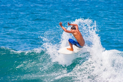 Man surfing waves at Montañita, Ecuador