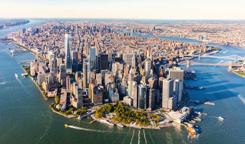 Aerial view of Lower Manhattan, New York City, surrounded by the Hudson River and East River, with boats sailing near the Financial District
