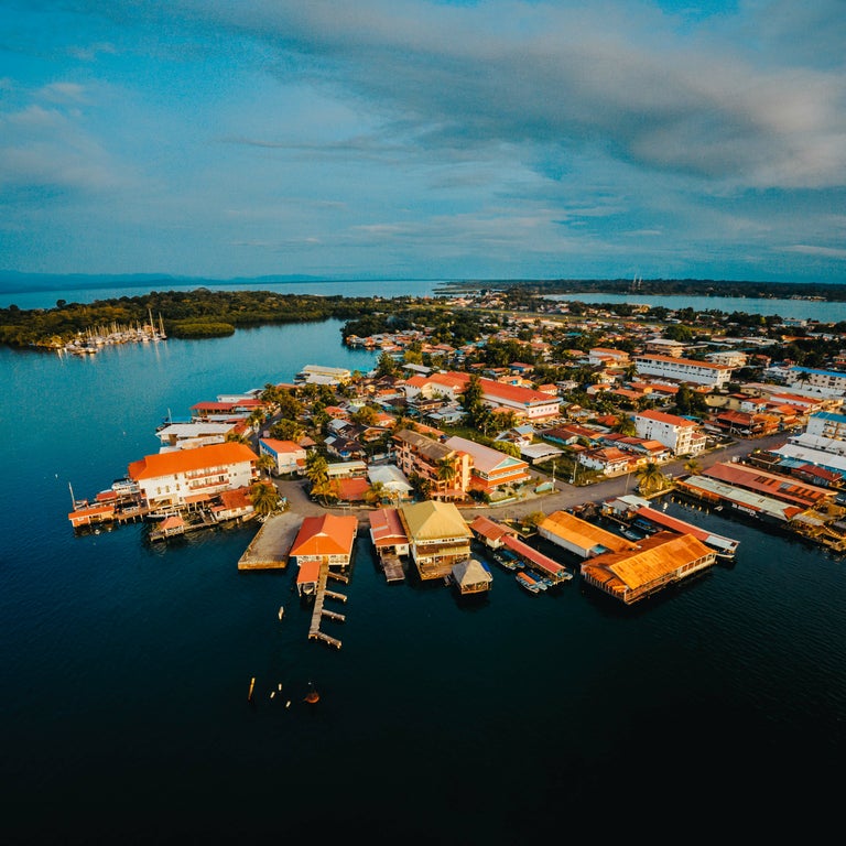 Aerial view of Bocas del Toro, Panama showing boats, typical Caribbean houses, and surrounded by turquoise sea