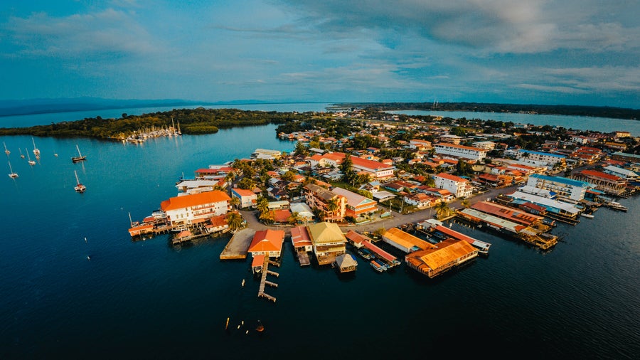 Aerial view of Bocas del Toro, Panama showing boats, typical Caribbean houses, and surrounded by turquoise sea