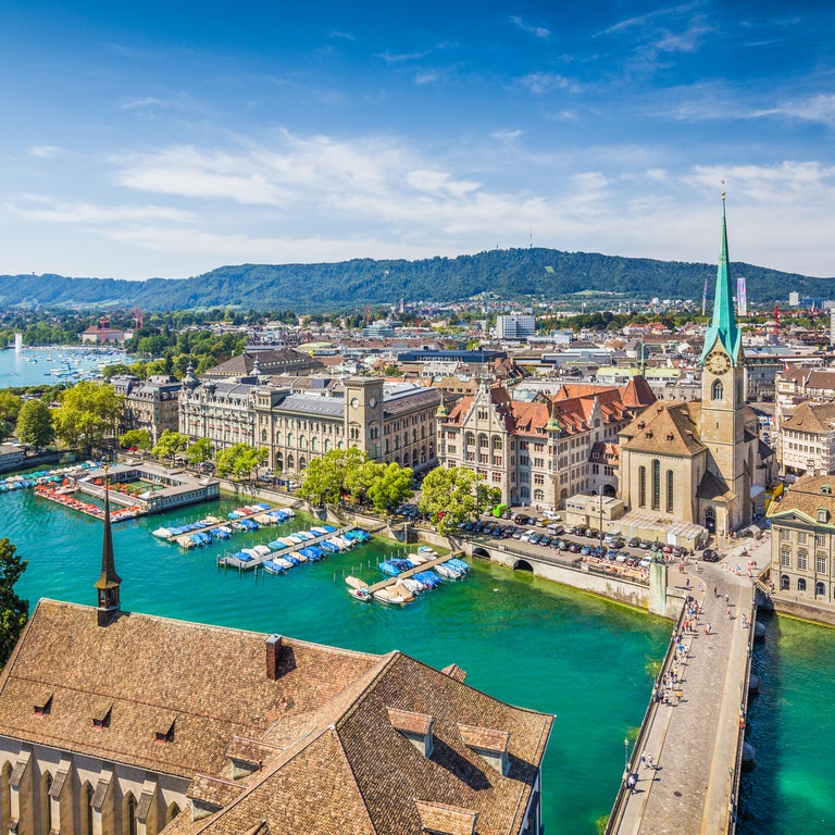 Aerial view of Zurich city center, Switzerland, with views of Grossmünster Church, Fraumünster Church, and historic buildings along the Limmat River