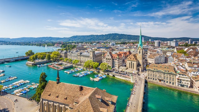 Aerial view of Zurich city center, Switzerland, with views of Grossmünster Church, Fraumünster Church, and historic buildings along the Limmat River