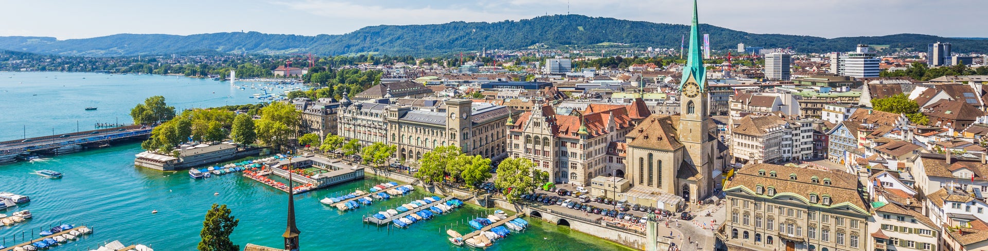 Aerial view of Zurich city center, Switzerland, with views of Grossmünster Church, Fraumünster Church, and historic buildings along the Limmat River