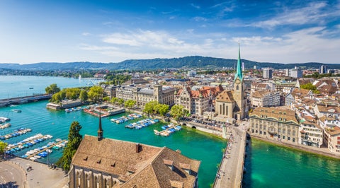 Aerial view of Zurich city center, Switzerland, with views of Grossmünster Church, Fraumünster Church, and historic buildings along the Limmat River