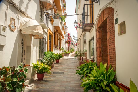 Narrow streets lined with traditional white houses in Marbella, Spain