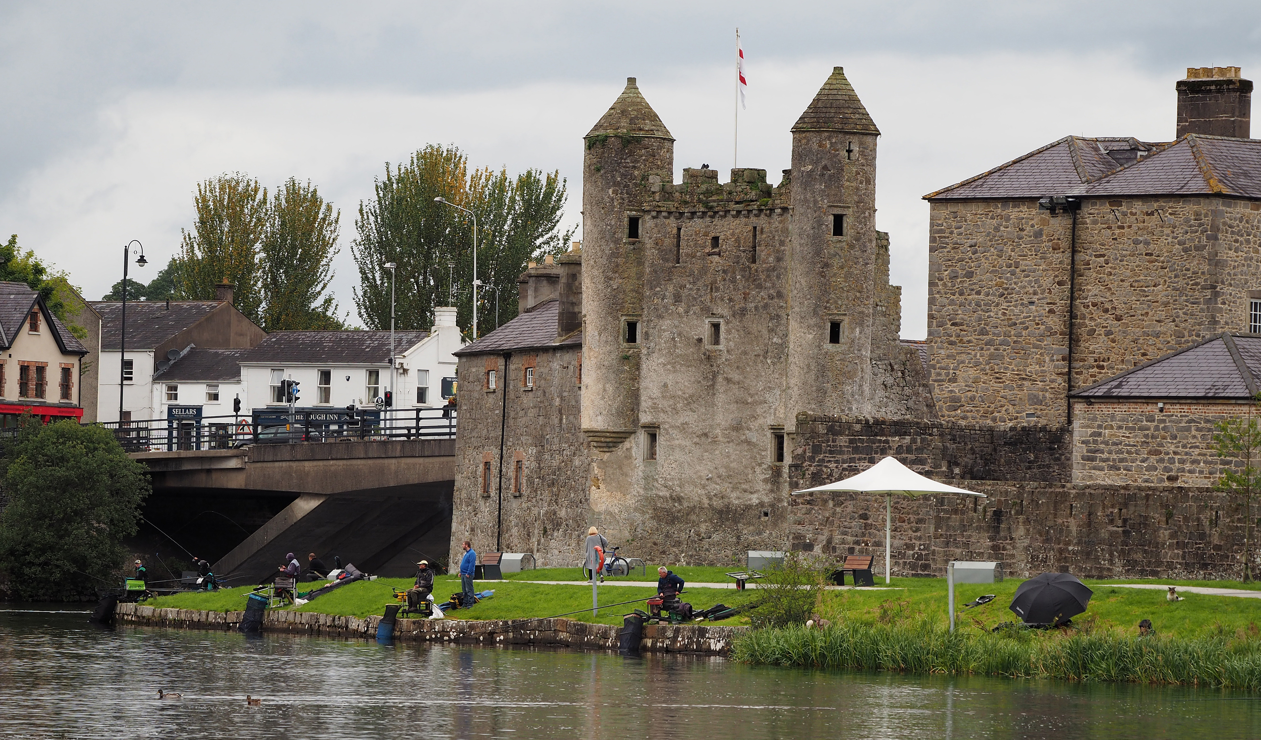 Fishermen competing in autumn on River Erne near Enniskillen Castle, Northern Ireland