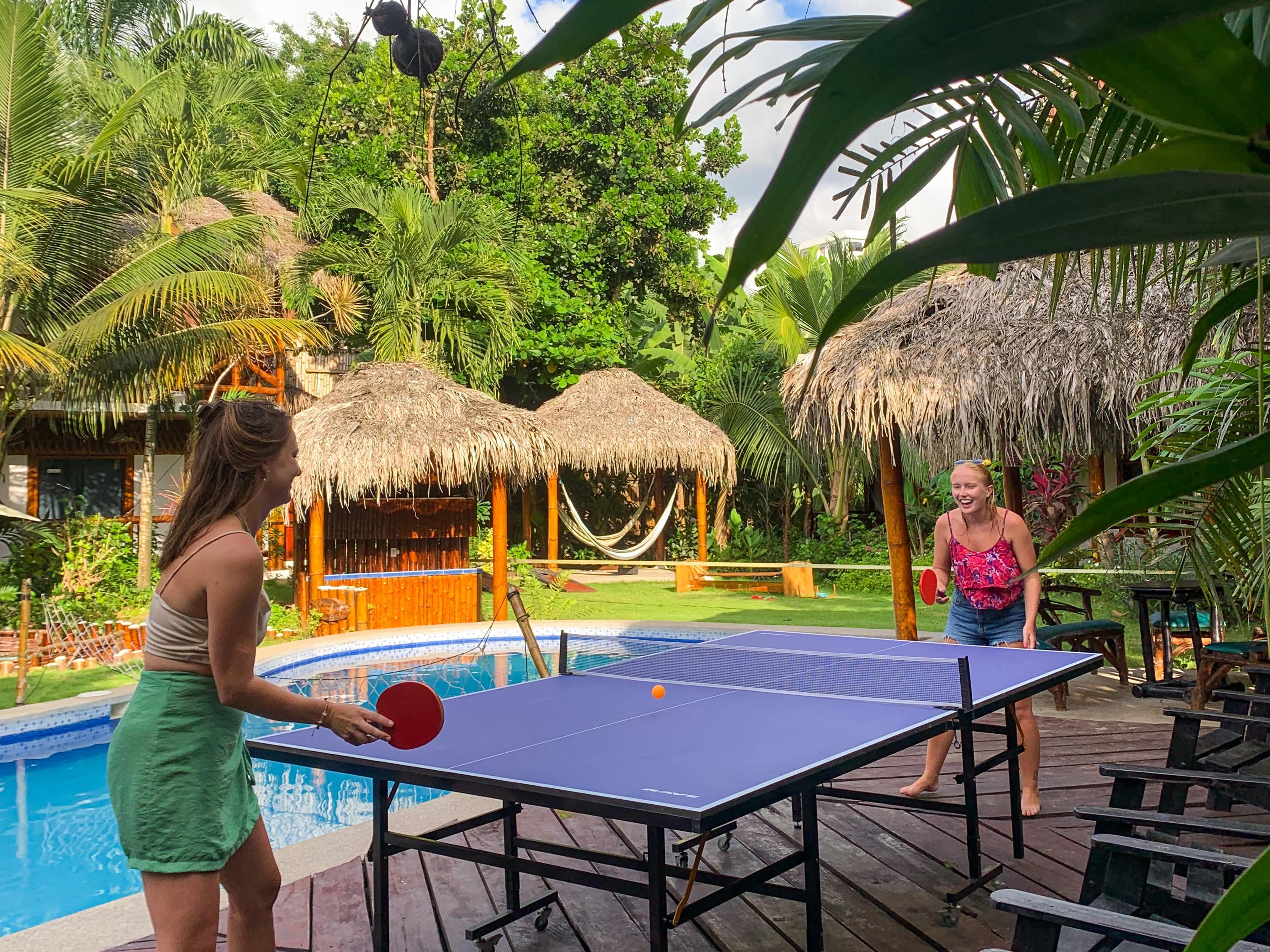 Two students playing ping pong