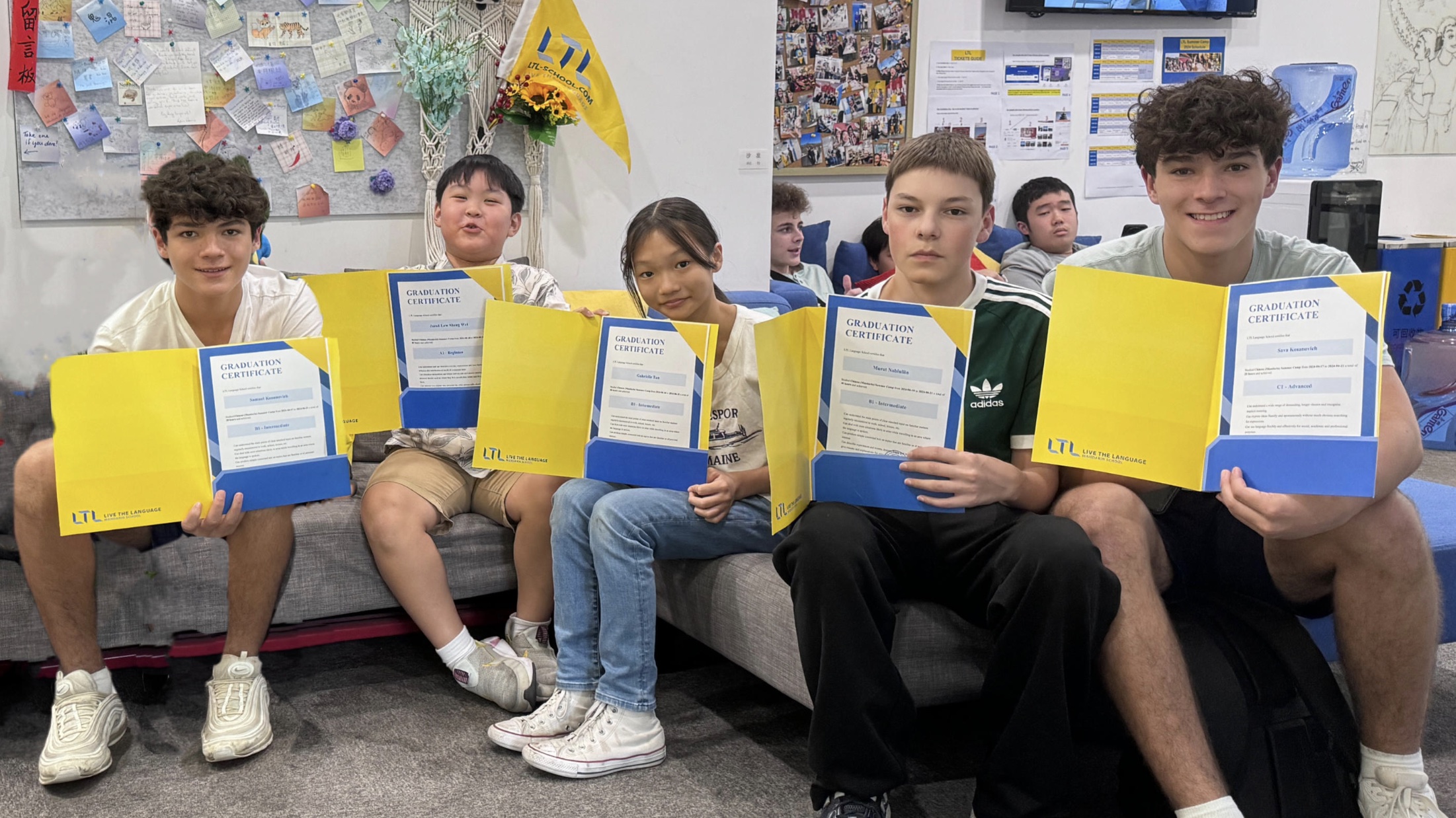 Students in school showing their diploma