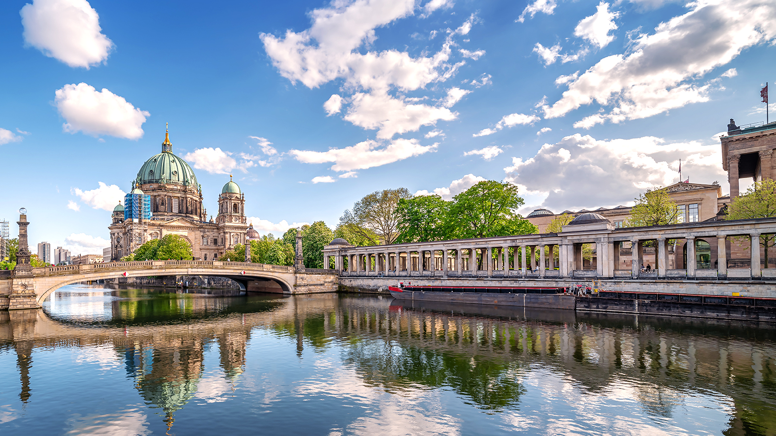 A scenic view of the Berlin Cathedral and the Spree River in Berlin, Germany, on a beautiful day, representing the cultural and historical exploration that enriches language study abroad programs.