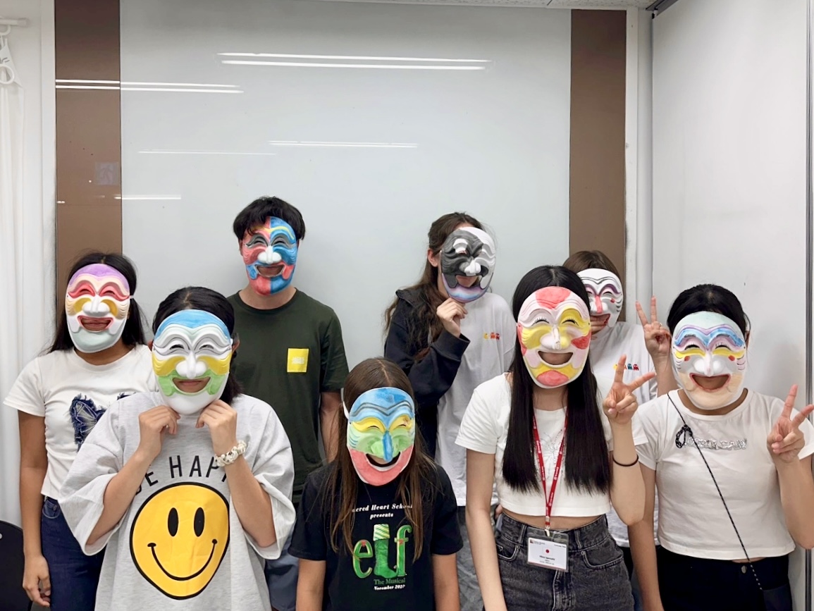 A group of students wearing traditional handmade Korean masks