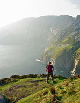 Tourist at Slieve League, Irelands highest sea cliffs, located in south west Donegal along this magnificent costal driving route. Popular stop at Wild Atlantic Way route, Ireland