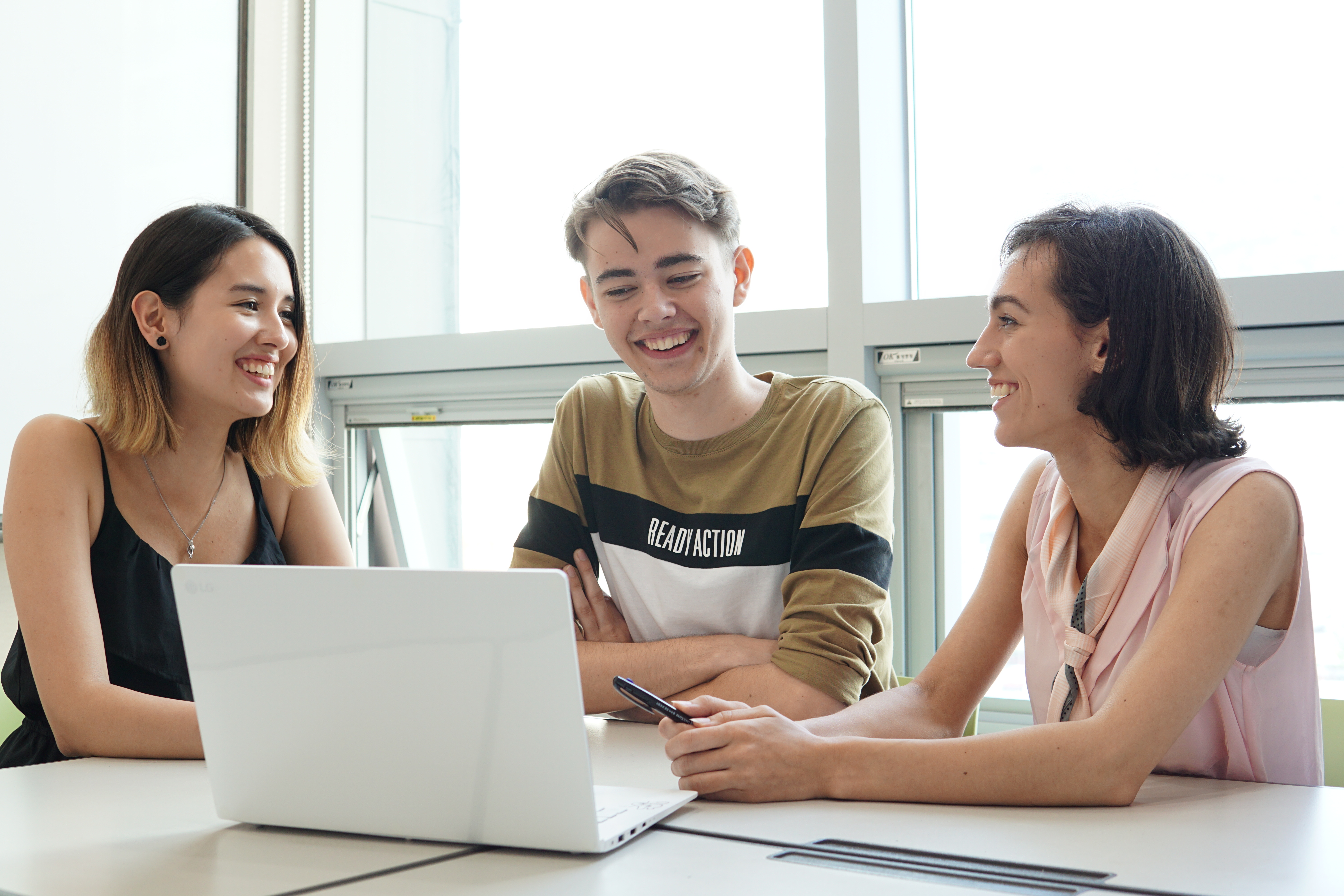 Three students working with a computer
