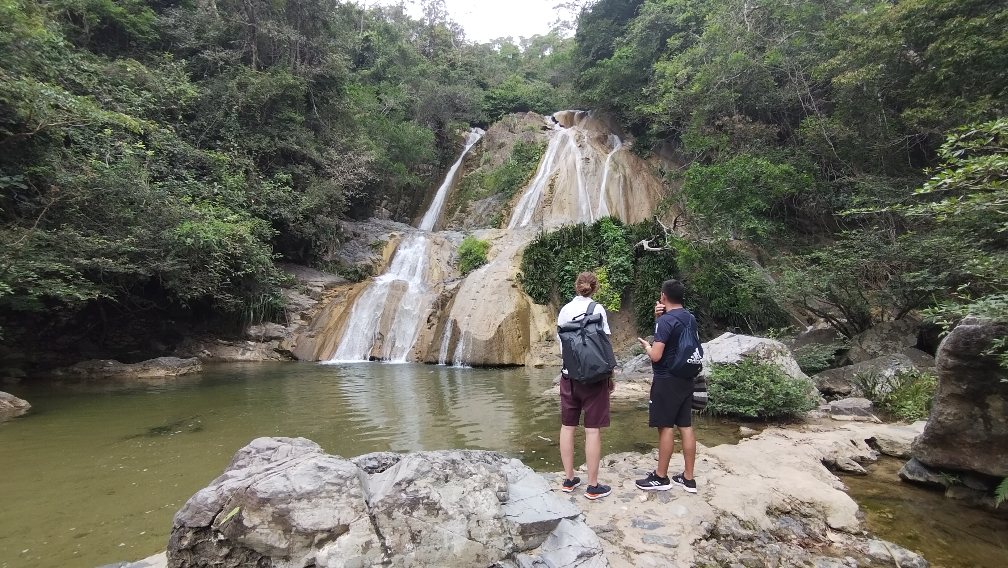 Two students visiting a waterfall