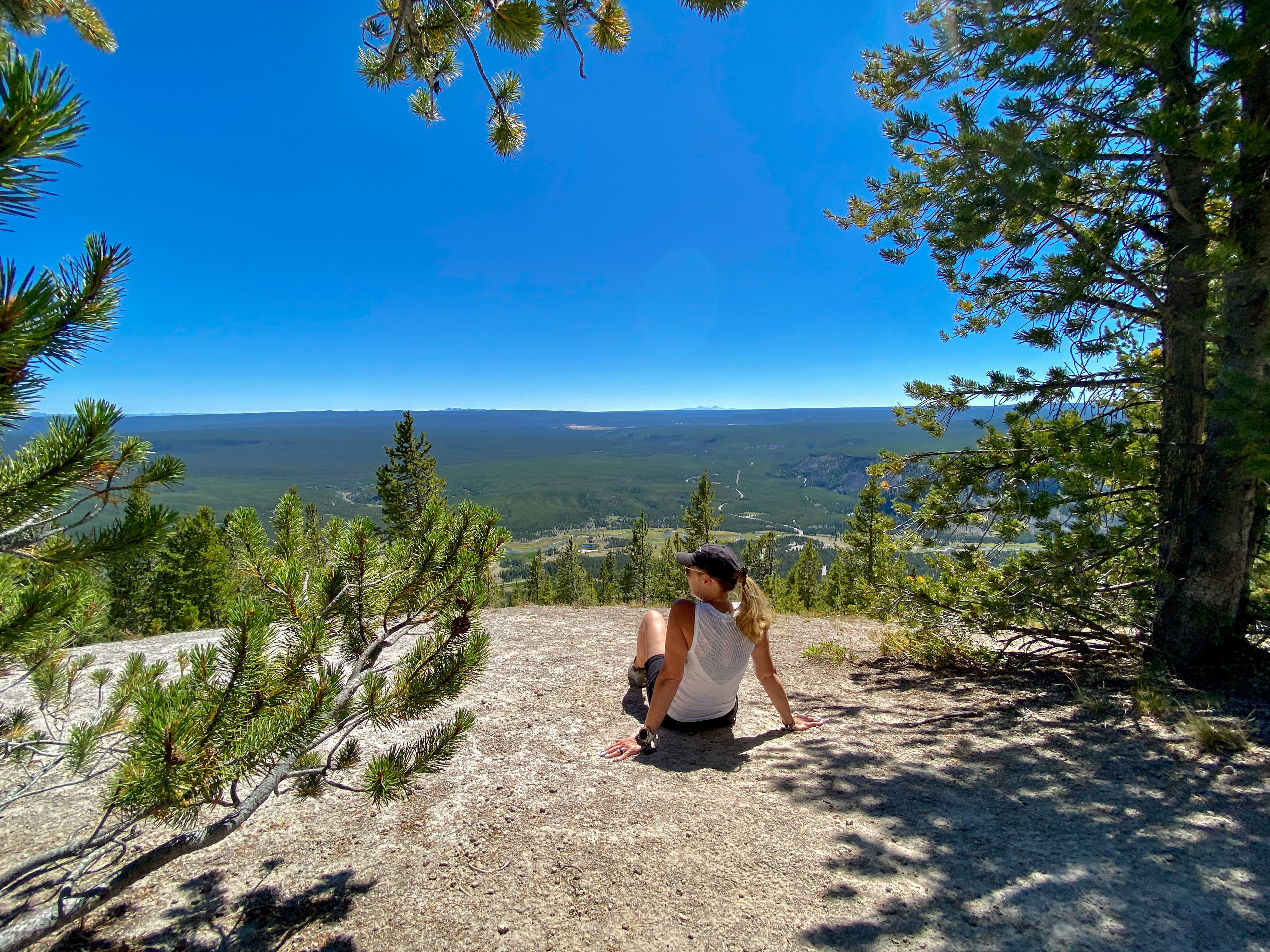 Hiker woman sitting on Purple Mountain overlooking Yellowstone valley