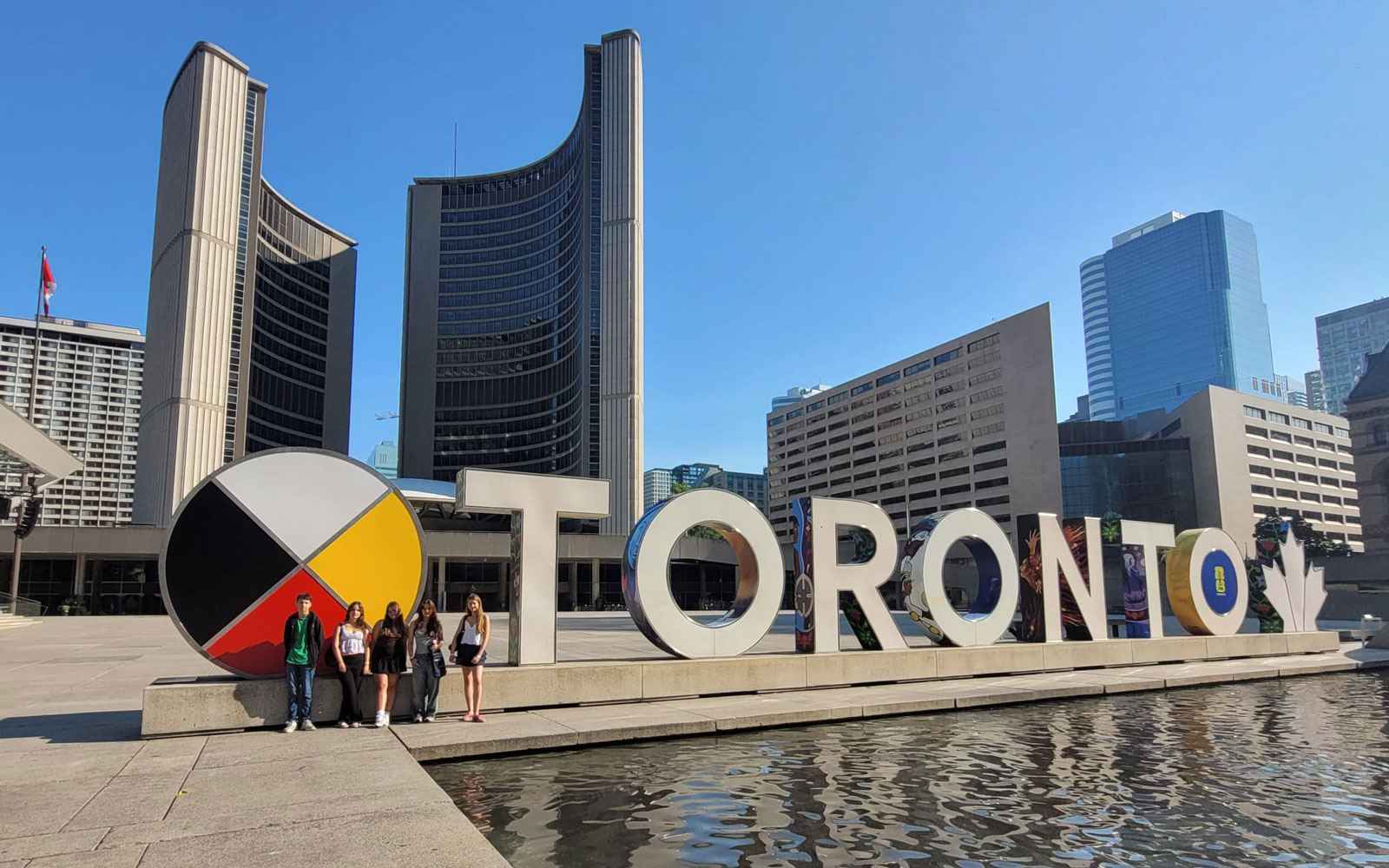 Students at Toronto sign in front of City Hall